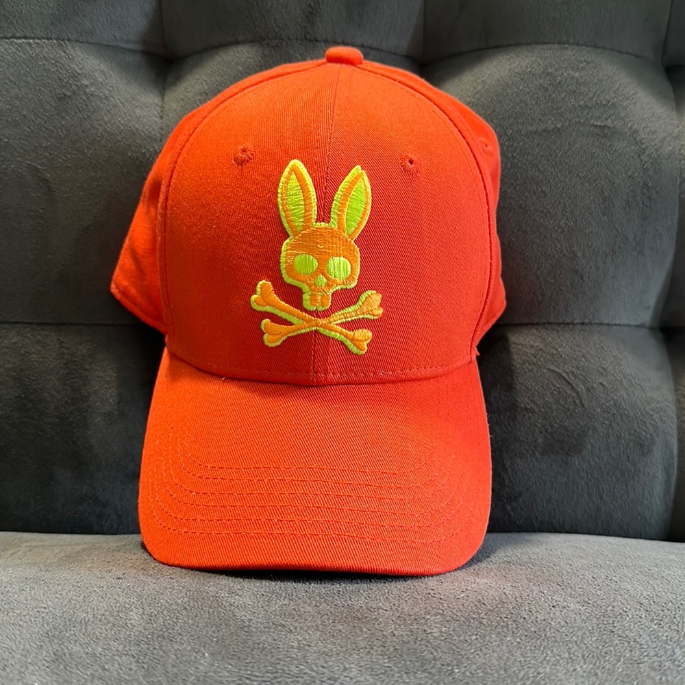 Adjustable Psycho Bunny Hat, Size O/S. Orange. Yellow logo.